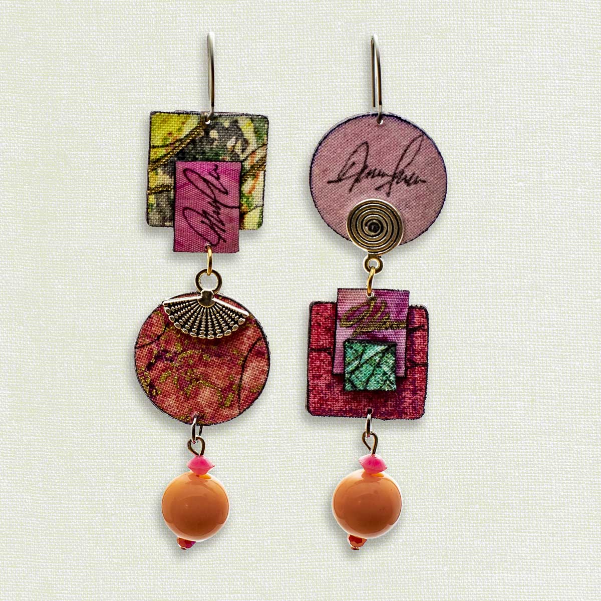 Asymmetric 3 tiered earrings, hand painted by artist Suzanne Bellows for SuzanneBellowsJewelry.com. This pair is part of the Soft Collection and features a variety of pinks and peaches.