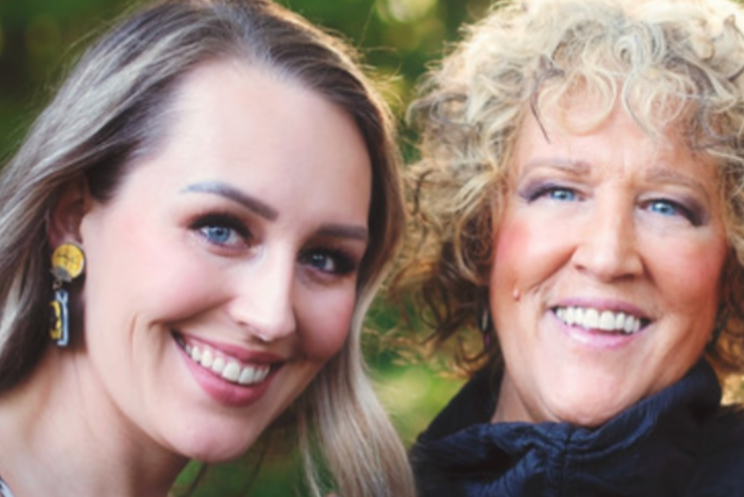 Suzanne Bellows and her niece  together outdoors with a blurred natural background