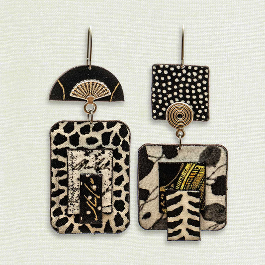 Asymmetric 2 tiered earrings hand painted by artist Suzanne Bellows for SuzanneBellowsJewelry.com. This pair is part of the Soft Collection and features bold black and white patterns.