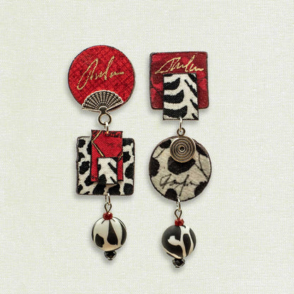 Asymmetric 3 tiered earrings, hand painted by artist Suzanne Bellows for SuzanneBellowsJewelry.com. This pair is part of the Graphic Collection and features bold black, red and white patterns.