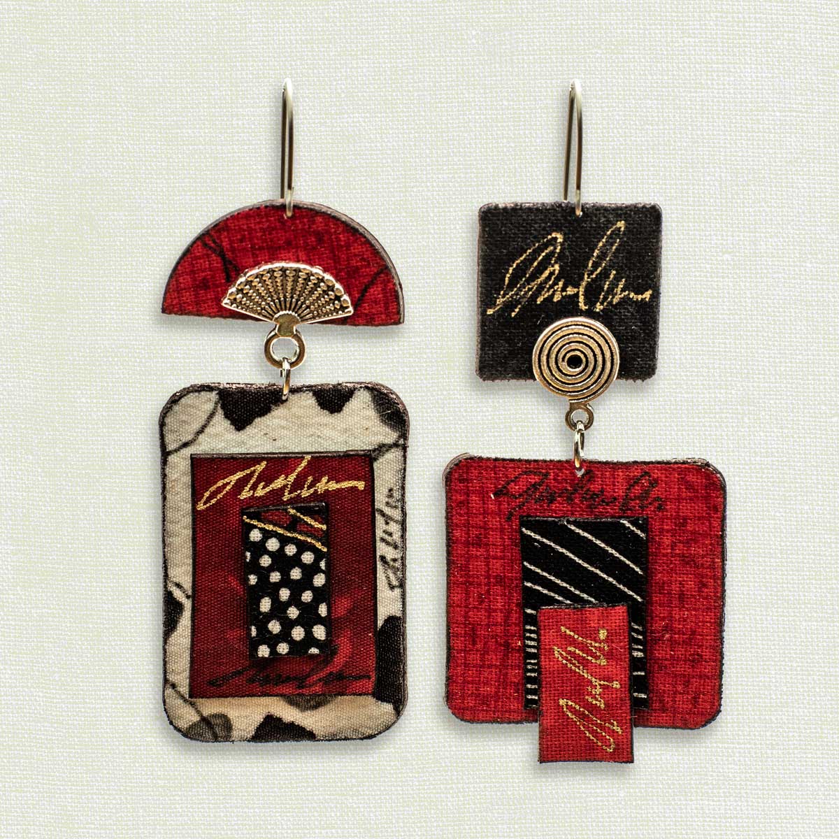 Asymmetric 2 tiered earrings hand painted by artist Suzanne Bellows for SuzanneBellowsJewelry.com. This pair is part of the Soft Collection and features striking black, white and red patterns.