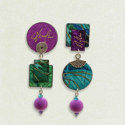 Asymmetric 3 tiered earrings, hand painted by artist Suzanne Bellows for SuzanneBellowsJewelry.com. This pair is part of the Water Collection and features a variety of Magentas and Greens.