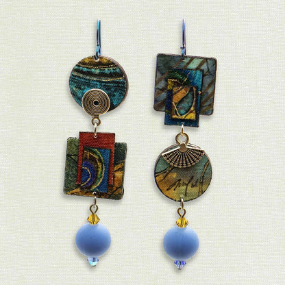 Asymmetric 3 tiered earrings, hand painted by artist Suzanne Bellows for SuzanneBellowsJewelry.com. This pair is part of the Earth Collection and features vibrant blues, greens  and red.