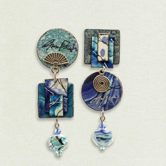 Asymmetric 3 tiered earrings, hand painted by artist Suzanne Bellows for SuzanneBellowsJewelry.com. This pair is part of the Water Collection and features a variety of blues.