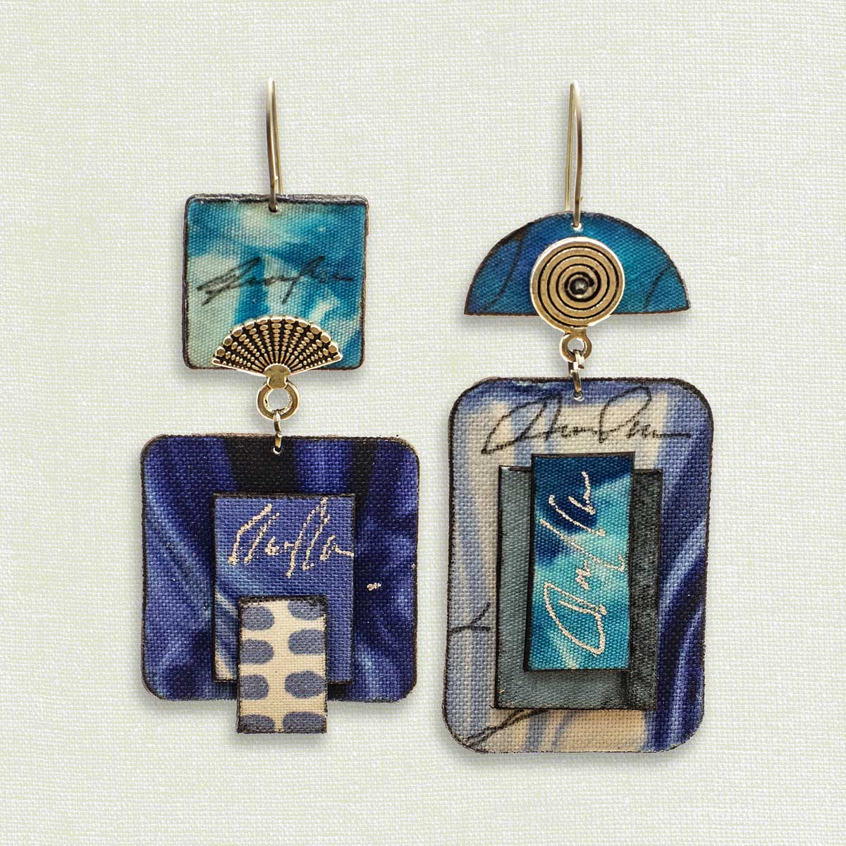 Asymmetric 2 tiered earrings hand painted by artist Suzanne Bellows for SuzanneBellowsJewelry.com. This pair is part of the Water Collection and features blues.